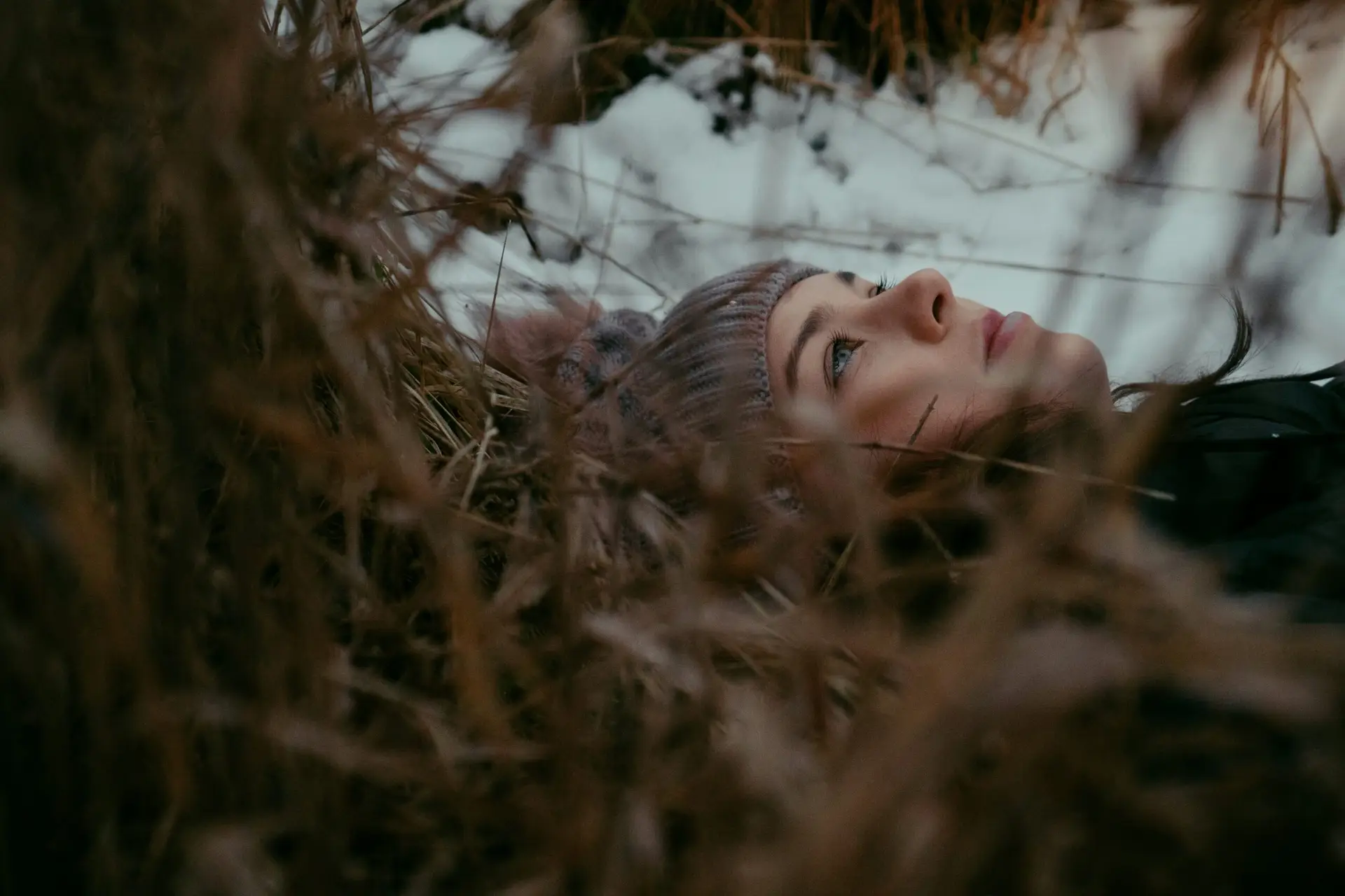 a woman is laying down in the snow